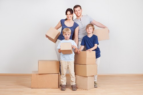 Professional movers handling office equipment